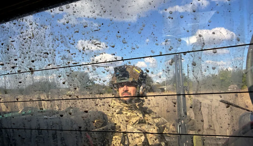 A serviceman of Ukraine's 141st Separate Mechanised Brigade rides on a pick up vehicle in Malomykhaylivka village in Dnipropetrovsk region on October 2, 2026, amid the Russian invasion of Ukraine. (Photo by Darya Nazarova (STR Zaporizhzhia)/AFP)