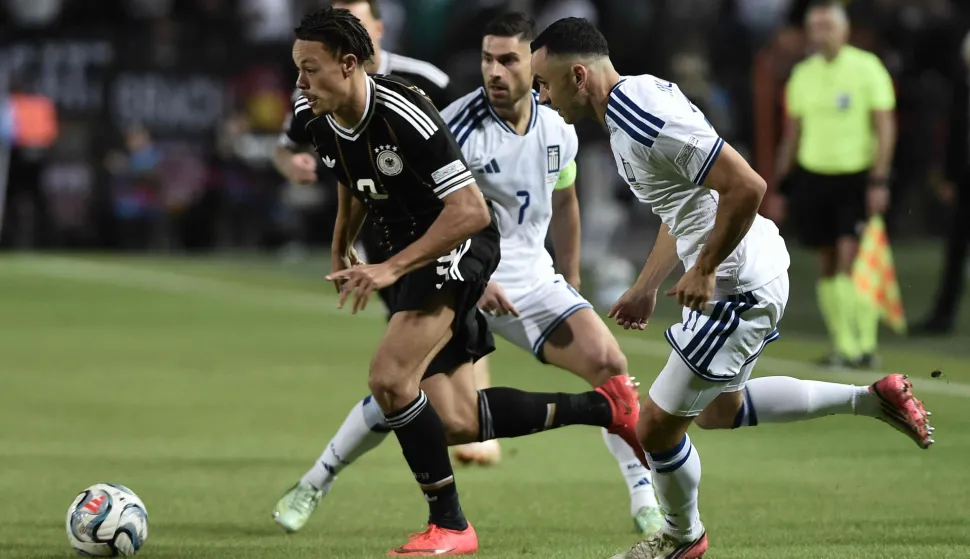 Germany's forward #09 Derry Scherhant (L) fights for the ball with Greece's forward #07 Giorgos Masouras (C) and Greece's defender #17 Manolis Saliakas (R) during the UEFA Nations League League A Group 2 matchday 4 match between Greece and Germany at Toumba Stadium in Thessaloniki on October 4, 2026. (Photo by Sakis Mitrolidis/AFP)
