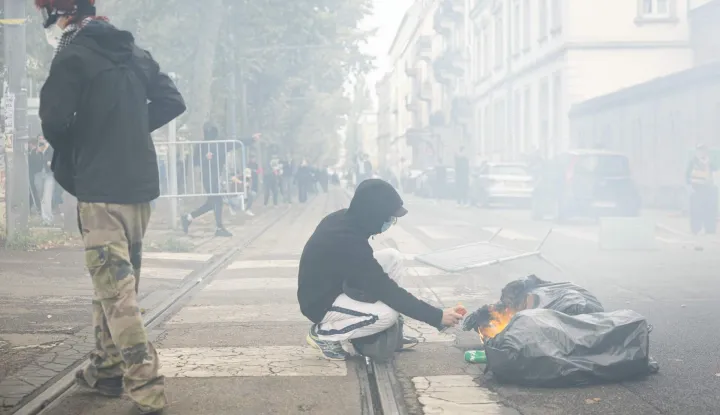 A student sets a trash bag on fire as students carry out a blocking protest at the Strasbourg University, in Strasbourg, eastern France, on October 2, 2026. (Photo by ROMEO BOETZLE/AFP)