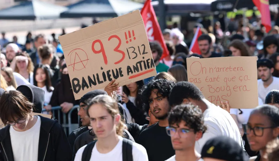 high school students hold a placard which reads as '"93 (93, suburb antifascist 1312" (1312 being the numeric code for the the abbreviation ACAB, a slogan for All Cops are Bastards), during a gathering amid a nationwide protest movement over school conditions in Saint-Denis, north of Paris, on October 4, 2026. Up to 500 schools across France will be totally or partly closed on October 5 due to the protests by teenage pupils that have shaken the country. movement. The teens at French high schools, known as lyc?es, say that their studies are being ruined by high teacher absences, overlong school days and dilapidated facilities as well as other grievances. (Photo by Kenzo TRIBOUILLARD/AFP)