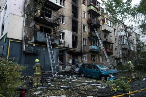 Rescuers work outside a damaged five-story residntial building following a Russian drone attack in Kyiv on October 7, 2026, amid the Russian invasion of Ukraine. (Photo by Vladyslav Musiienko/AFP)