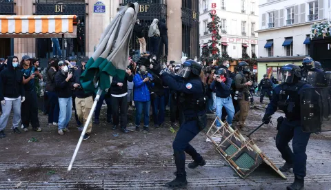French police officers clash with protesters during a demonstration of high-school students at Place de la Bastille, in Paris, on October 8, 2026, as part of a nationwide protest movement over learning conditions. Since late September, pupils have barred the entrances to hundreds of schools, complaining of teacher absences, overloaded timetables, dilapidated classrooms and buildings ill-adapted to rising temperatures, among other grievances. (Photo by Kenzo TRIBOUILLARD/AFP)
