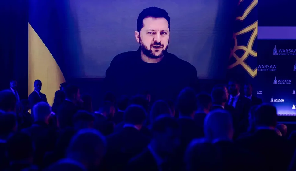 Participants listen as Ukraine's President Volodymyr Zelensky speaks via videolink during the opening session of the Warsaw Security Forum in Warsaw, Poland on October 12, 2026. (Photo by Wojtek RADWANSKI/AFP)