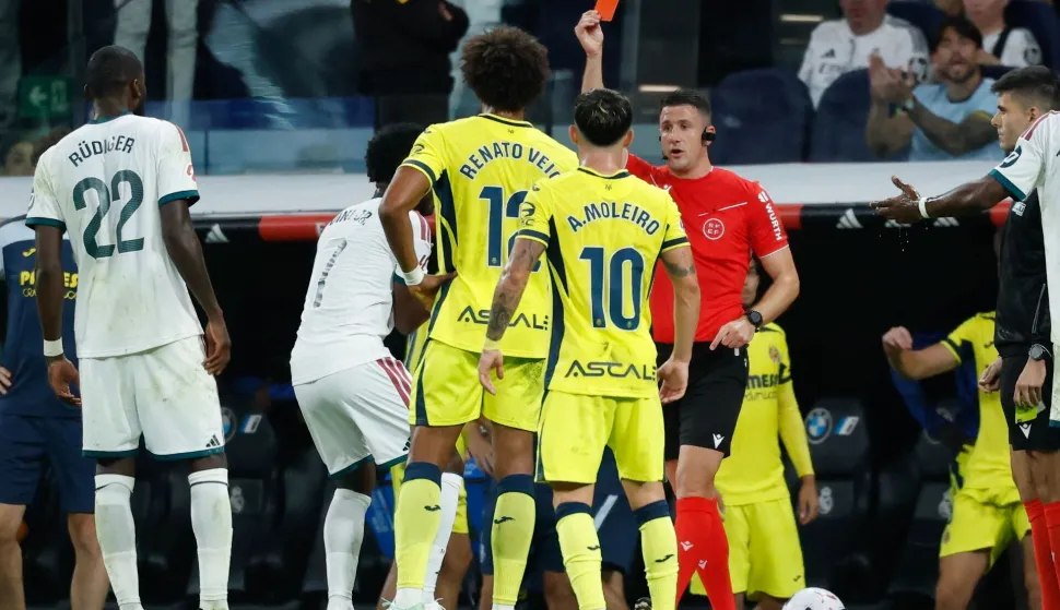 Referee Isidro Escuderos shows a red card to Real Madrid's Brazilian forward #07 Vinicius Junior (2L) during the Spanish league football match between Real Madrid CF and Villarreal CF at the Santiago Bernabeu Stadium in Madrid on October 10, 2026. (Photo by Oscar DEL POZO/AFP)