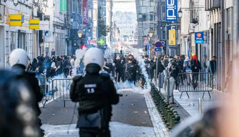 Riot police fire tear gas as students gather outside several schools during a protest against education reforms and budget cuts, in Liege on October 2026. (Photo by JONAS ROOSENS/Belga/AFP)/Belgium OUT