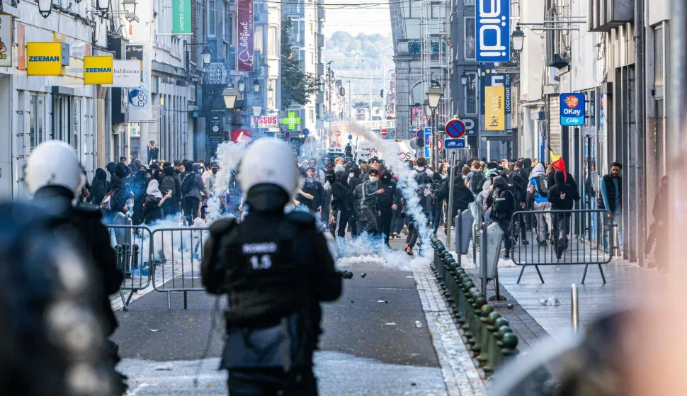 Riot police fire tear gas as students gather outside several schools during a protest against education reforms and budget cuts, in Liege on October 2026. (Photo by JONAS ROOSENS/Belga/AFP)/Belgium OUT