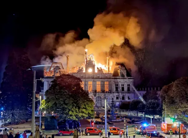 This photograph shows a fire burning and destroying the city hall after a group of individuals forced entry into the building during ongoing protest action against the "high cost of living", in Limoges, central France on October 17, 2026 as part of a nationwide call for mobilisation bringing together various groups expressing their anger: former "Yellow Vest", secondary school and university students, climate activists and even farmers. After weeks of student protests, France faces broader, nationwide demonstrations on October 17, 2026 over the cost of living, setting up a potentially fraught six months heading into a presidential election. A police source told AFP that authorities estimated nearly 200,000 people could take part, with 40,000 in Paris. (Photo by Melaine PAYZAL/AFP)