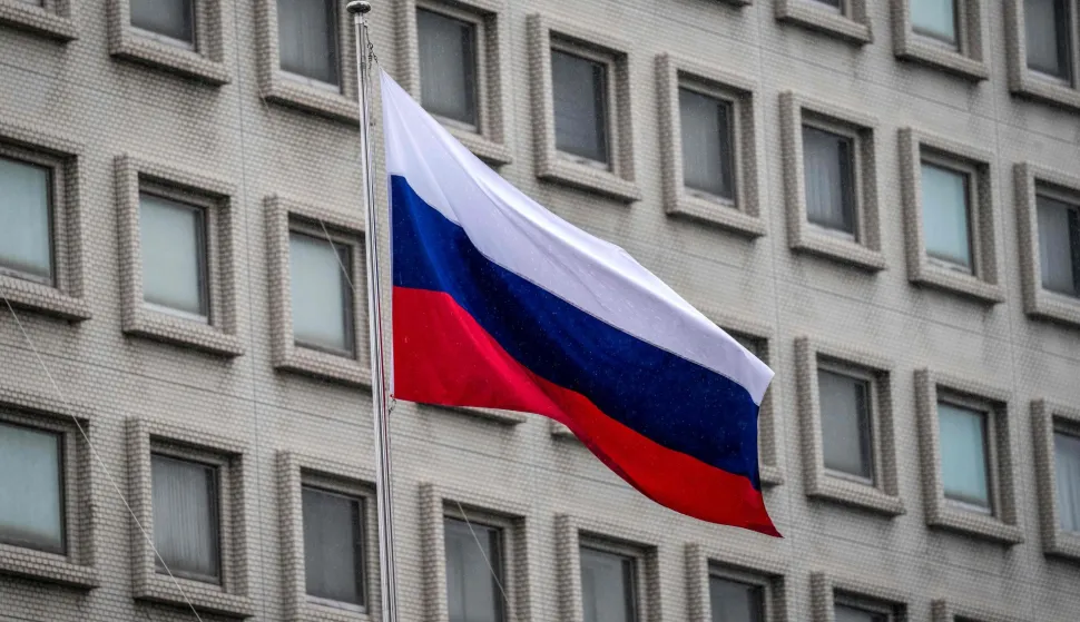 Russia's national flag is seen at the Russian Embassy in Tokyo on October 14, 2026. Tokyo said October 14 it had urged Moscow to ensure "fair and impartial treatment" for a Japanese journalist who was arrested by Russia on suspicion of espionage. (Photo by Yuichi YAMAZAKI/AFP)
