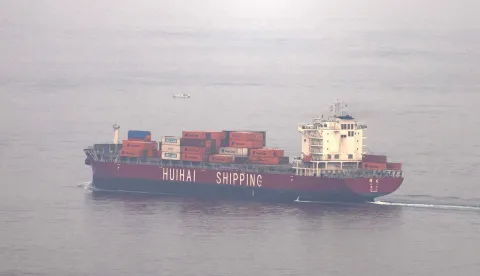 The Chinese-flagged container shipping vessel Hui Fa transits the Gulf of Oman off the coast of Khor Fakkan in the emirate of Sharjah in the east of the UAE on October 13, 2026. The International Monetary Fund (IMF) has sharply cut growth forecasts for the Middle East and Central Asia in 2026, citing "a longer closure of the Strait of Hormuz, compared with the baseline assumptions in the April" report, and predicting a major rebound in 2027 based on the expected reopening of the waterway. (Photo by AFP)