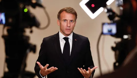 France's President Emmanuel Macron speaks to members of the media on the day of the 9th Annual One Planet Sovereign Wealth Funds (OPSWF) Summit in Lusail on October 21, 2026. The French president is undertaking a tour of key energy suppliers in the Gulf in an effort to secure oil and diesel and bring down prices in France. (Photo by Benoit Tessier/POOL/AFP)