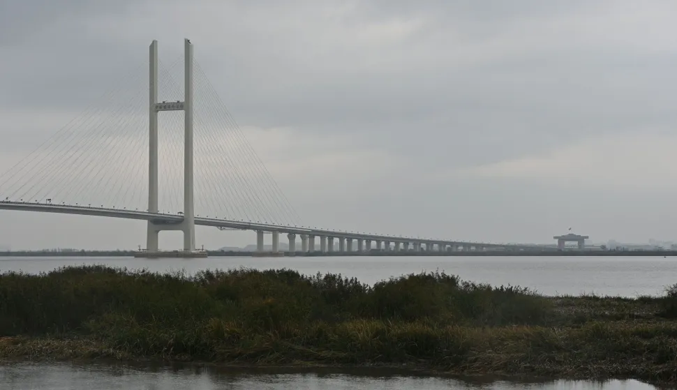 A general view shows the new cross-border bridge linking China and North Korea in Dandong, Liaoning Province, on October 15, 2026. A new four-lane road bridge linking China and North Korea finally opened on October 15, 12 years late, enabling the Asian giant and its isolated nuclear-armed neighbour to step up cross-border trade substantially. (Photo by Michael ZHANG/AFP)