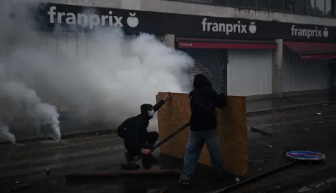 Protesters clash with police near Porte de Vincennes during a demonstration in favor of purchasing power, the protection of public services, and fiscal and social justice, in Paris on October 24, 2026 as part of a nationwide call for mobilisation bringing together former members of the Yellow Vest movement, labor unions, high school and university students. Protests by high school students over learning conditions sparked a movement that has since spread nationwide, fuelled by broader anger over the rising cost of living. About 70,000 security personnel will be deployed on October 24, 2026, Interior Minister said at a news conference, warning that calls for violence and looting were circulating on social media. (Photo by Aris MESSINIS/AFP)