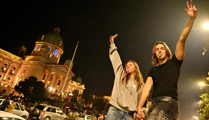 Supporters of the Students? List gather at the National assembly building as they celebrate their victory in the Serbian parliamentary elections, in Belgrade in the early hours of October 26, 2026. Voters cast ballots in record numbers on October 25, 2026, with the country recording its highest parliamentary election turnout in more than three decades. Celebrations erupted on the streets of the capital; passing cars honked their horns as crowds began to party at the news that Serbia's ruling party had lost parliamentary snap elections. (Photo by Andrej ISAKOVIC/AFP)