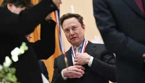 Elon Musk reacts after being awarded the National Medal of Science during the "Golden Age of American Innovation Summit" at the Institute of Peace in Washington, DC, on October 8, 2026. (Photo by Kent NISHIMURA/AFP)